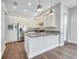 Beautiful white kitchen with stainless steel appliances and granite countertops at 13852 Maskawa Ave, Orlando, FL 32827