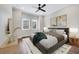 Cozy bedroom featuring a ceiling fan, plush carpet, and natural light at 13852 Maskawa Ave, Orlando, FL 32827