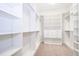 A well-organized walk-in closet with ample shelving and hanging space for storage solutions at 13852 Maskawa Ave, Orlando, FL 32827