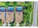 An aerial view shows the roof lines and private, screened in pools of two neighboring homes at 1400 Moon Valley Dr, Davenport, FL 33896