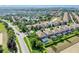 Aerial view of a neighborhood with homes, community pool, landscaping and golf course at 1400 Moon Valley Dr, Davenport, FL 33896