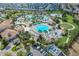 Aerial view of a community pool area with pools, landscaping, lounge chairs, and buildings at 1400 Moon Valley Dr, Davenport, FL 33896
