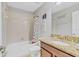 Bathroom with a tub and shower combination, a vanity with granite countertops, and tile flooring at 1400 Moon Valley Dr, Davenport, FL 33896