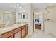 Bathroom featuring a double sink vanity with granite countertops and a glass-enclosed shower at 1400 Moon Valley Dr, Davenport, FL 33896