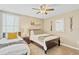 Cozy bedroom featuring two twin beds, decor, and a bedside table with a lamp at 1400 Moon Valley Dr, Davenport, FL 33896