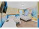 The Beauty and the Beast themed bedroom includes two beds and unique custom wall art at 1400 Moon Valley Dr, Davenport, FL 33896