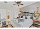 Inviting bedroom featuring a spacious bed, ceiling fan, and custom wall art at 1400 Moon Valley Dr, Davenport, FL 33896