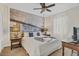 Cozy bedroom with a comfortable bed, ceiling fan, and custom wall art at 1400 Moon Valley Dr, Davenport, FL 33896