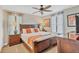 Comfortable bedroom with a bed, side tables, lamps, and curtains at 1400 Moon Valley Dr, Davenport, FL 33896
