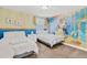 Bedroom featuring two beds, custom wallpaper, and stylish chandelier at 1400 Moon Valley Dr, Davenport, FL 33896