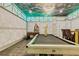 Fun game room with pool table, foosball, arcade machine and custom ceiling at 1400 Moon Valley Dr, Davenport, FL 33896