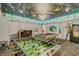 Spacious game room with foosball, pool table, and unique ceiling art at 1400 Moon Valley Dr, Davenport, FL 33896