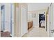 Hallway with access to stairs, the bathroom, and bedroom; tiled floor and neutral paint at 1400 Moon Valley Dr, Davenport, FL 33896