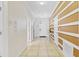 Bright hallway with tile flooring and decorative wall trim, leading to the main entrance at 1400 Moon Valley Dr, Davenport, FL 33896