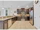 Well-equipped kitchen with granite countertops, dark wood cabinets, and stainless steel appliances at 1400 Moon Valley Dr, Davenport, FL 33896