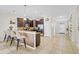 Modern kitchen features dark cabinets, stainless steel appliances, tile backsplash, and breakfast bar with seating at 1400 Moon Valley Dr, Davenport, FL 33896