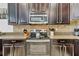 Close-up of a kitchen with granite countertops and dark cabinets at 1400 Moon Valley Dr, Davenport, FL 33896
