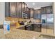 Kitchen featuring granite countertops, tiled backsplash, and modern appliances at 1400 Moon Valley Dr, Davenport, FL 33896