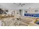 Bright living room showcases modern decor, including a large sofa, glass coffee table, and unique wall art at 1400 Moon Valley Dr, Davenport, FL 33896