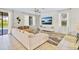 Comfortable living room with large sectional, modern entertainment center, and plenty of natural light at 1400 Moon Valley Dr, Davenport, FL 33896