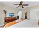Inviting bedroom featuring a ceiling fan, TV, closet, and access to an en-suite bathroom at 1400 Moon Valley Dr, Davenport, FL 33896