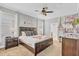 Spacious main bedroom featuring a ceiling fan, ensuite bathroom, and neutral decor at 1400 Moon Valley Dr, Davenport, FL 33896
