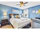 Comfortable bedroom with a ceiling fan, side tables, and large window at 1400 Moon Valley Dr, Davenport, FL 33896