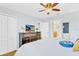 Comfortable bedroom with a ceiling fan, television, and attached bathroom at 1400 Moon Valley Dr, Davenport, FL 33896