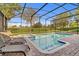 Enjoy the outdoors by the large pool and lounge area within the screened enclosure at 1400 Moon Valley Dr, Davenport, FL 33896