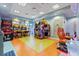 Fun game room featuring various driving games and arcade games that are all brightly lit at 1563 Sandbagger Dr, Davenport, FL 33896