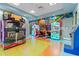 Arcade room featuring various Jurassic Park themed games, claw games, and bright wall decor at 1563 Sandbagger Dr, Davenport, FL 33896