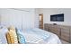 Comfortable bedroom with a TV, dresser, and ensuite bathroom at 1563 Sandbagger Dr, Davenport, FL 33896