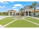 Lush community clubhouse and grounds with a water fountain and palm trees at 1563 Sandbagger Dr, Davenport, FL 33896