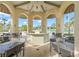 Covered dining area near the pool with ceiling fans and views of tropical landscaping at 1563 Sandbagger Dr, Davenport, FL 33896