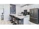 Contemporary kitchen with a breakfast bar, sleek appliances, and stylish design at 1563 Sandbagger Dr, Davenport, FL 33896