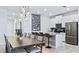 Modern kitchen featuring stainless steel appliances, a chalkboard menu, and stylish dining area at 1563 Sandbagger Dr, Davenport, FL 33896