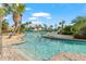 Community lazy river winds through tropical landscaping with palm trees and lounge chairs at 1563 Sandbagger Dr, Davenport, FL 33896