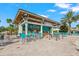 Poolside bar with bar seating, TVs, and tables with chairs surrounded by palm trees at 1563 Sandbagger Dr, Davenport, FL 33896