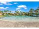 Resort-style swimming pool with beach access, playground, slide, and tropical landscaping at 1563 Sandbagger Dr, Davenport, FL 33896