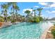Relax and unwind in this large swimming pool with a slide, palm trees, and lounge chairs at 1563 Sandbagger Dr, Davenport, FL 33896