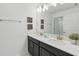Well-lit bathroom featuring double sinks, a large mirror, framed wall art, and modern fixtures at 1570 Sandbagger Dr, Davenport, FL 33896