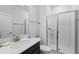 Bright bathroom featuring a glass enclosed shower, white tile, ample counter space, and modern fixtures at 1570 Sandbagger Dr, Davenport, FL 33896