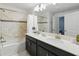 Bathroom featuring a double sink vanity with modern fixtures, and a shower-tub combo at 1570 Sandbagger Dr, Davenport, FL 33896
