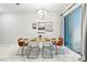 Cozy dining area with modern lighting fixture and view of the outdoor patio at 1570 Sandbagger Dr, Davenport, FL 33896