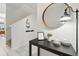 Bright foyer featuring tile flooring, a modern mirror, and stylish decorative accents at 1570 Sandbagger Dr, Davenport, FL 33896
