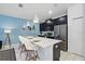 Modern kitchen boasting a spacious island, stainless steel appliances, and bright lighting at 1570 Sandbagger Dr, Davenport, FL 33896