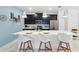 Modern kitchen featuring a large island with white countertop and black cabinets at 1570 Sandbagger Dr, Davenport, FL 33896