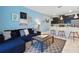 Open living space with a comfortable sofa, modern art, and a kitchen island with seating at 1570 Sandbagger Dr, Davenport, FL 33896