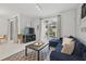Relaxing living area showcasing stylish decor, a comfortable sofa, and a view of the outdoor pool area at 1570 Sandbagger Dr, Davenport, FL 33896