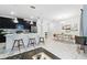 Open-concept living space with kitchen island, dining area, and modern furnishings with lots of natural light at 1570 Sandbagger Dr, Davenport, FL 33896